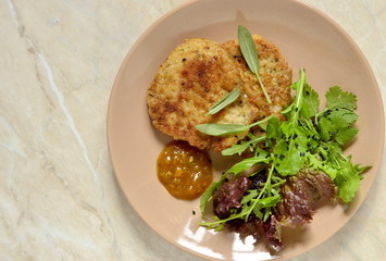 Fried pork chop with fresh herbs and fruit sauce, top view, copy space