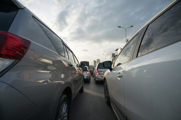 Fototapeta na wymiar Cars on city street in traffic jam at rush hour