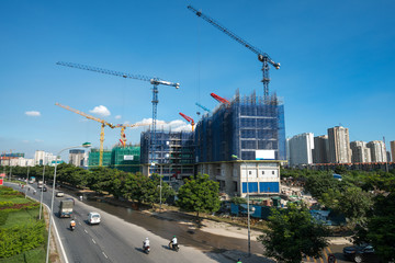 Fototapeta na wymiar Modern city with highway traffic and building under construction. Hanoi city, Thang Long highway