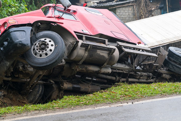 Accident on mountainous road, motor vehicle accident, car wreck. Long vehicle overturned and lying in ditch on side © Hanoi Photography