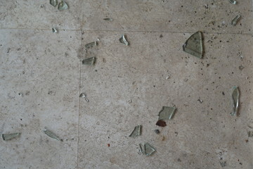 Shards of broken glass on the tiled floor