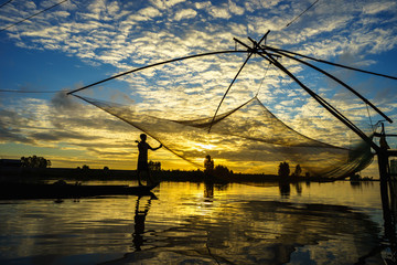 Sunrise scene in Tha La cultivation field with fishing net in Chau Doc, An Giang province, South Vietnam