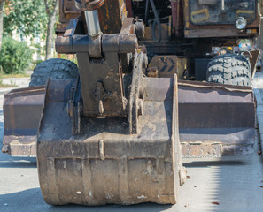 bucket old excavator on the street day