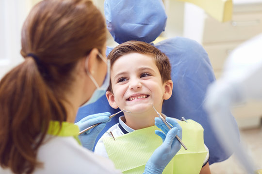 A child with a dentist in a dental office. Dental treatment in a children's clinic.