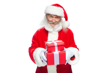 Christmas. Smiling Santa Claus in white gloves is holding two gift red boxes with a bow, one on the other. Isolated on white background.