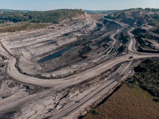 Fototapeta premium Open pit mine, extractive industry for coal, top view aerial drone