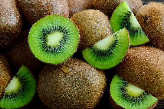 A lot of fresh Kiwi fruits  on wooden floor.
Kiwis are a nutrient dense food, they are high in nutrients and low in calories.