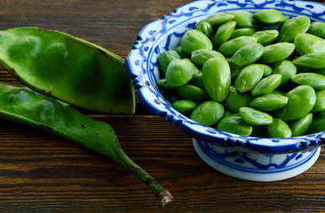 Parkia speciosa or English name is bitter bean, twisted cluster bean or stink bean and Thai name is sataw or sator  on wooden background.