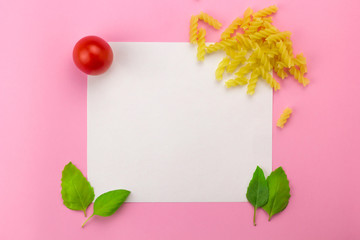 small ripe tomatoes, fresh basil,pasta flat lay row,   top view flat lay frame white white sheet of paper, copy space, mock up  with empty space  for cooking recipe