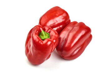 Red ripe bellpeppers, isolated on white background.
