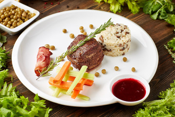 fillet mignon with rice bacon and vegetables