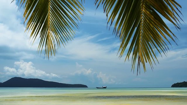 View of  Tropical Saracen Bay beach with palm leaves on the sky. Koh Rong Samloem island. Cambodia, Asia.  