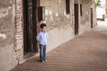 Fototapeta na wymiar Standing Little Boy with Hands Behind