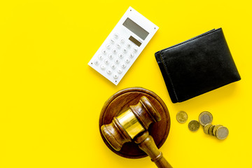 Financial failure, bankruptcy concept. Judge gavel, wallet, coins, calculator on yellow background top view copy space