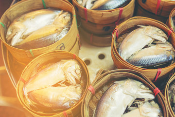 Thai Mackerel fishes in round bamboo basket for sale in local market. 