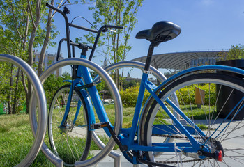 A blue bicycle parked in the park