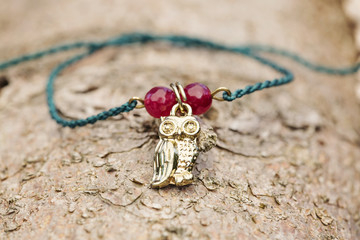 Tiny fashionable female bracelet on wooden background