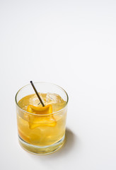 Cocktail with orange garnish on white background