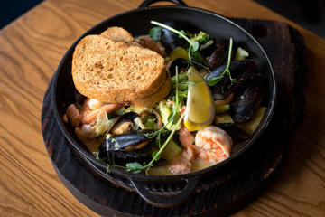 delicious sea dish in a cast iron plate