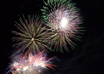 fireworks in different reflected colors, multicolour festive fireworks in night sky