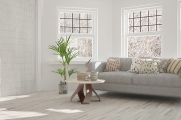 White room with sofa and winter landscape in window. Scandinavian interior design. 3D illustration