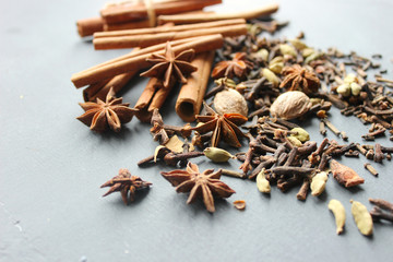 Various Spices background. Cinnamon sticks and anise stars close-up on wood background. Copy space