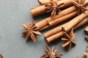Various Spices background. Cinnamon sticks and anise stars close-up on wood background. Copy space
