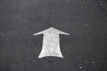 the arrow on the asphalt