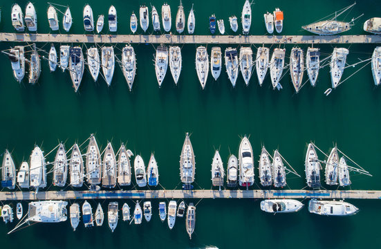 Yacht parking, A marina lot, yachts and sailboats are moored at the quay.