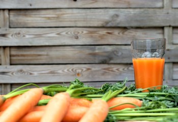 Healthy eating,tasty and vegetable concept-natural homemade carrot juice in glass on an old wooden background.