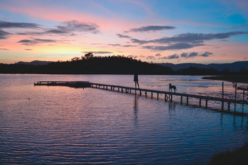 Fototapeta na wymiar cute sunrise on the pier over the lake