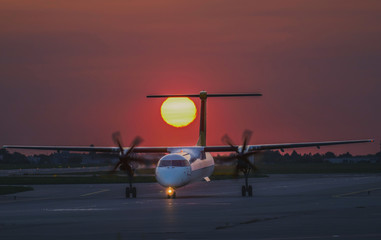 Aircraft taxiing in the sunset