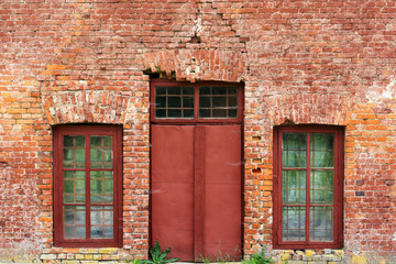 old door and old windows in an old brick wall