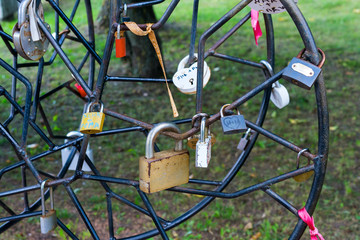 Symbolic love padlocks fixed to the railings of  bridge