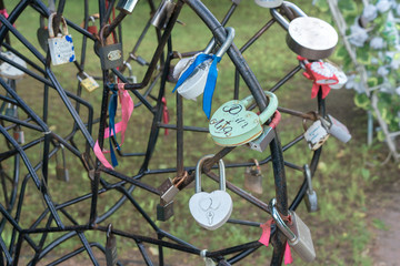 Symbolic love padlocks fixed to the railings of  bridge