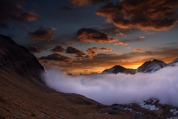 Great view of the foggy valley in Gran Paradiso National Park,  Alps, Italy,  dramatic scene, beautiful world. colourful autumn morning,scenic view with cloudy sky, majestic dawn in mountain landscape