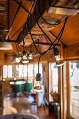 Close up of lightening chandeliers in wooden log cabin