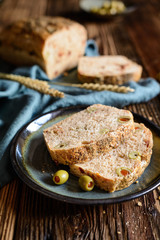 Homemade loaf of bread with sun dried tomato and olives