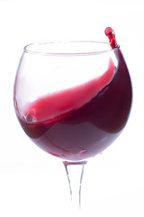 A glass with red wine on a white background. Isolate