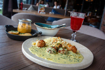Lunch with meatballs and rice and red drink