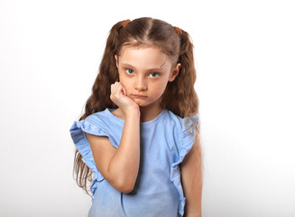 Beautiful girl looking sad with pouted lips. Closeup portarit of cute kid with long hair on white background