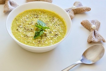 Tasty carrot broccoli cream soup in the white bowl.