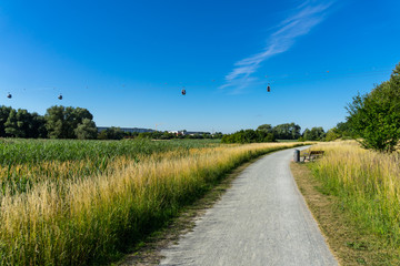 Summer natural landscape. A sunny day and hiking trails and cable car trails against the blue sky.