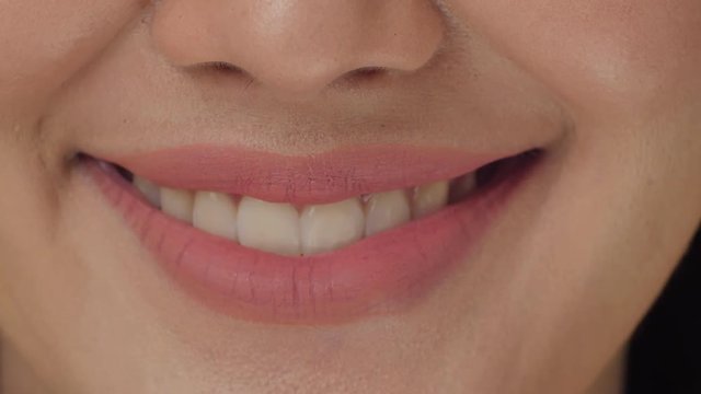 Smiling woman mouth with great white teeth close up.