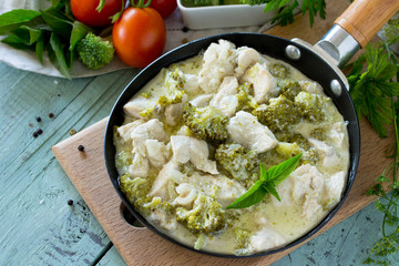 Fototapeta na wymiar Healthy food: Chicken Stew with Broccoli and Sour Cream on wooden table. Diet menu. Copy space.