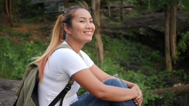 Tourist woman sitting on the rock mountain