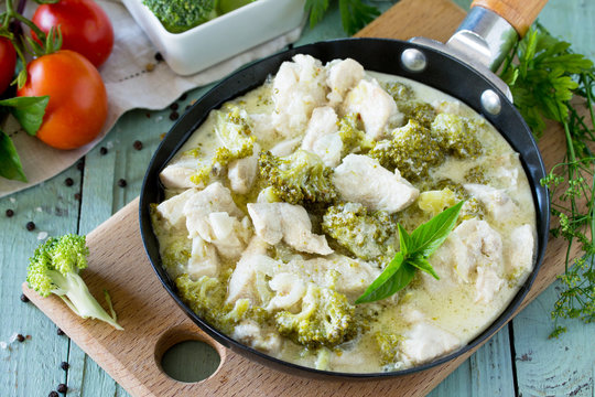 Healthy food: Chicken Stew with Broccoli and Sour Cream oon wooden table. Diet menu.