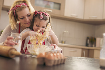 Mother and daughter having fun in the kitchen