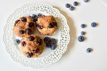 Tasty blueberry sweet muffins on the white plate.