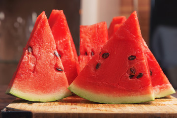 Slices of watermelon on a wooden cutting board